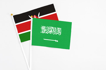 Saudi Arabia and Kenya stick flags on white background. High quality fabric, miniature national flag. Peaceful global concept.White floor for copy space.