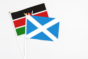 Scotland and Kenya stick flags on white background. High quality fabric, miniature national flag. Peaceful global concept.White floor for copy space.