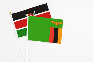 Zambia and Kenya stick flags on white background. High quality fabric, miniature national flag. Peaceful global concept.White floor for copy space.
