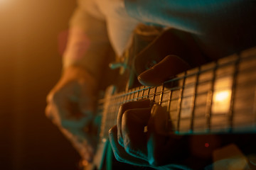 Fototapeta premium Guy plays a melody on the stage