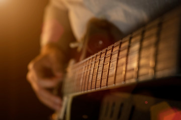 Fototapeta premium Play th guitar, man plays the guitar on the stage