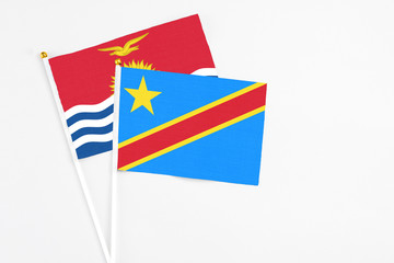Congo and Kiribati stick flags on white background. High quality fabric, miniature national flag. Peaceful global concept.White floor for copy space.