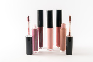 Fashion lip gloss collection of different colors and shades isolated on white background.