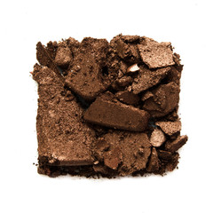 Eyeshadow sample isolated on white background. Crushed brown metallic eyeshadow. The concept of fashion and beauty industry. Copy Space. - Image