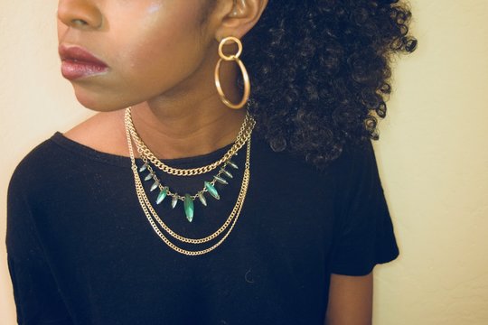 African American Women Wearing Gold and Green Necklace