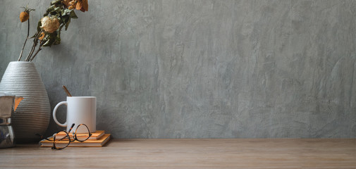 Vintage workspace with dry roses with office supplies and copy space