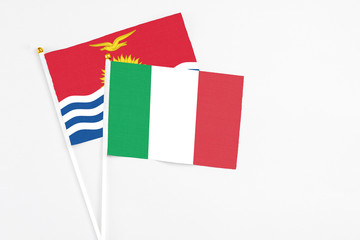 Italy and Kiribati stick flags on white background. High quality fabric, miniature national flag. Peaceful global concept.White floor for copy space.
