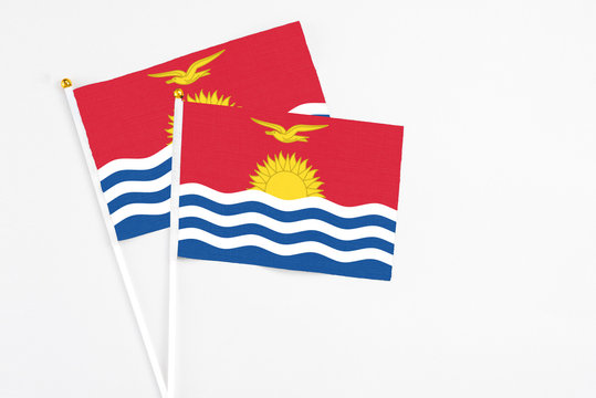 Kiribati and Kiribati stick flags on white background. High quality fabric, miniature national flag. Peaceful global concept.White floor for copy space.