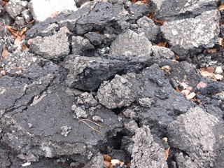 broken asphalt thrown in the trash and litters nature