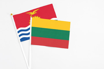 Lithuania and Kiribati stick flags on white background. High quality fabric, miniature national flag. Peaceful global concept.White floor for copy space.