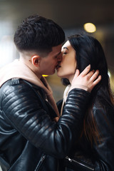 Young couple in love hug each other and kisses  in underground crossing. Love story. Happy to be together. Love, romantic, passion, tenderness concept.