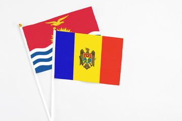 Moldova and Kiribati stick flags on white background. High quality fabric, miniature national flag. Peaceful global concept.White floor for copy space.