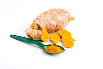 Turmeric powder on spoon and slice Turmeric  isolated on white background.