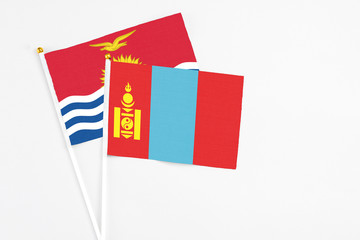 Mongolia and Kiribati stick flags on white background. High quality fabric, miniature national flag. Peaceful global concept.White floor for copy space.