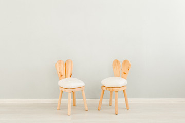 Mock up wall in child room interior. Children's chairs near the wall. Interior scandinavian style.