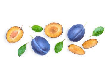 fresh blue plum and half with leaves isolated on white background with copy space for your text. Top view. Flat lay