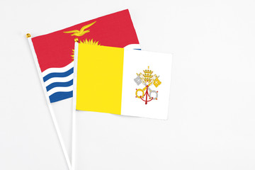 Vatican City and Kiribati stick flags on white background. High quality fabric, miniature national flag. Peaceful global concept.White floor for copy space.