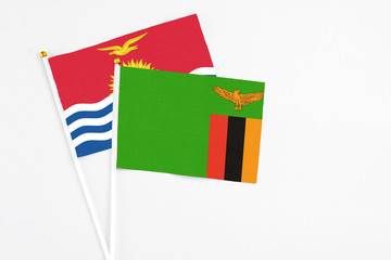 Zambia and Kiribati stick flags on white background. High quality fabric, miniature national flag. Peaceful global concept.White floor for copy space.