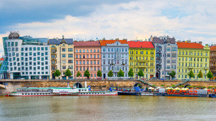 Multicolored buildings in Prague on the Moldavian river