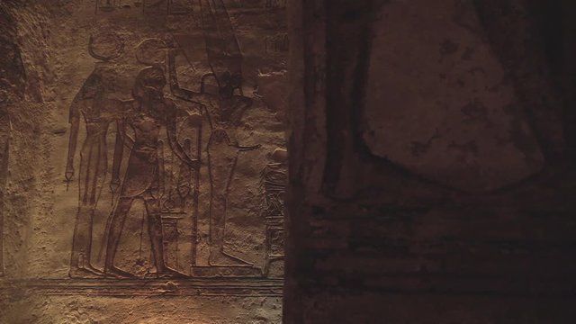 Slow motion travelling shot of a wall with hieroglyphs in the temple of Abu Simbel.