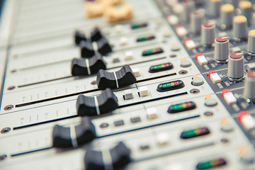 Close-up volume slide of digital sound mixer in the studio for recording, editing, and Sound system control concept.