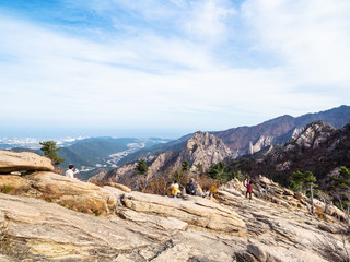people on rocks over Sokcho city in Seoraksan