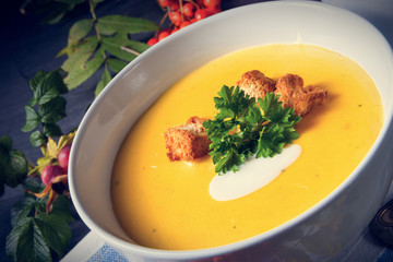 Delicious pumpkin soup with croutons and coconut milk