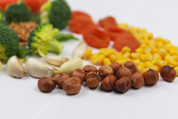 Healthy food. Carrots, dried apricots, garlic, broccoli, nuts, hazelnuts. Food on a white background