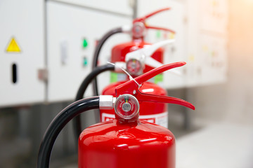 The red fire extinguisher is in the building.