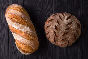 Top view photo of fresh baked bread on painted black wooden table
