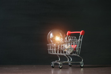 Shopping cart with light bulb.