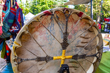 Naklejka premium Sacred Native American drum, close up picture outdoors during a spiritual gathering, traditional music instrument