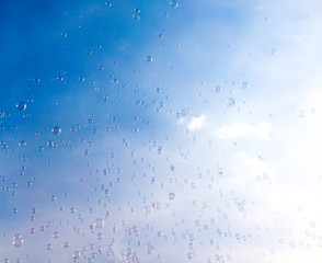 Soap bubbles fly in the blue sky