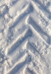 Traces of a car on white snow