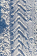 Traces of a car on white snow