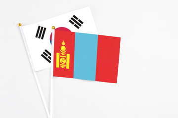 Mongolia and South Korea stick flags on white background. High quality fabric, miniature national flag. Peaceful global concept.White floor for copy space.