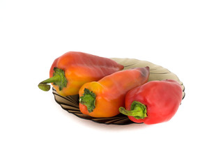 Red peppers on a plate white background