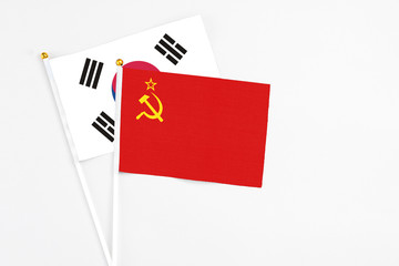 Soviet Union and South Korea stick flags on white background. High quality fabric, miniature national flag. Peaceful global concept.White floor for copy space.