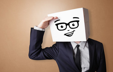 Handsome man standing and gesturing with a carton box on his head