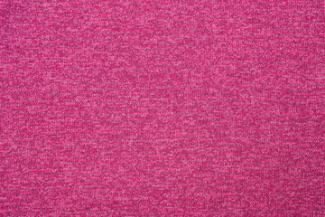 Fragment of knitted fabric. Pink background.