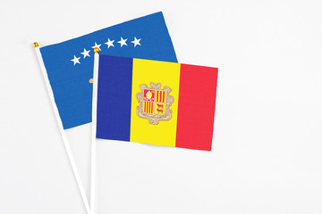 Andorra and Kosovo stick flags on white background. High quality fabric, miniature national flag. Peaceful global concept.White floor for copy space.