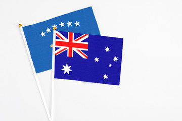 Australia and Kosovo stick flags on white background. High quality fabric, miniature national flag. Peaceful global concept.White floor for copy space.