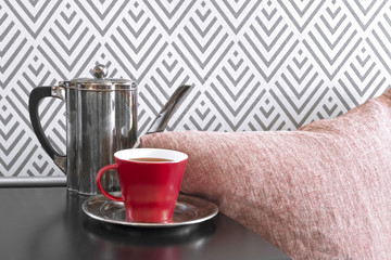 Cozy interior with red cup of tea