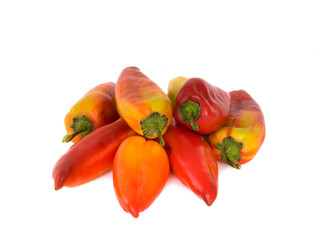 Reds and yellow peppers on a platy on a white background