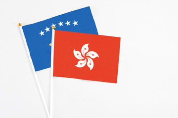 Hong Kong and Kosovo stick flags on white background. High quality fabric, miniature national flag. Peaceful global concept.White floor for copy space.