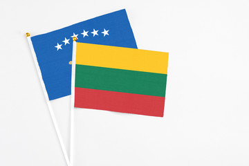 Lithuania and Kosovo stick flags on white background. High quality fabric, miniature national flag. Peaceful global concept.White floor for copy space.