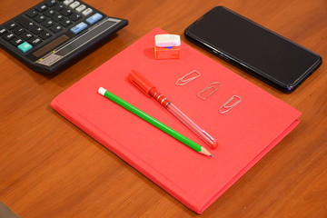 notebook and pen on wooden table
