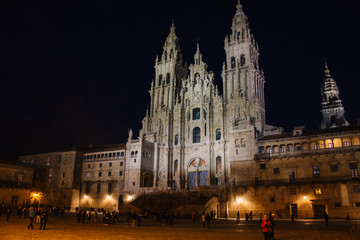 Fototapeta na wymiar Santiago de Compostela, Spain - 10/18/2018: Square near illuminated Cathedral of Saint James in Santiago de Compostela. Famous cathedral on Camino de Santiago at night. Pilgrimage concept.