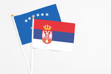Serbia and Kosovo stick flags on white background. High quality fabric, miniature national flag. Peaceful global concept.White floor for copy space.