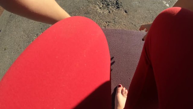 Woman Rolling Yoga Mat Onto Ground In Park - First Person POV Perspective